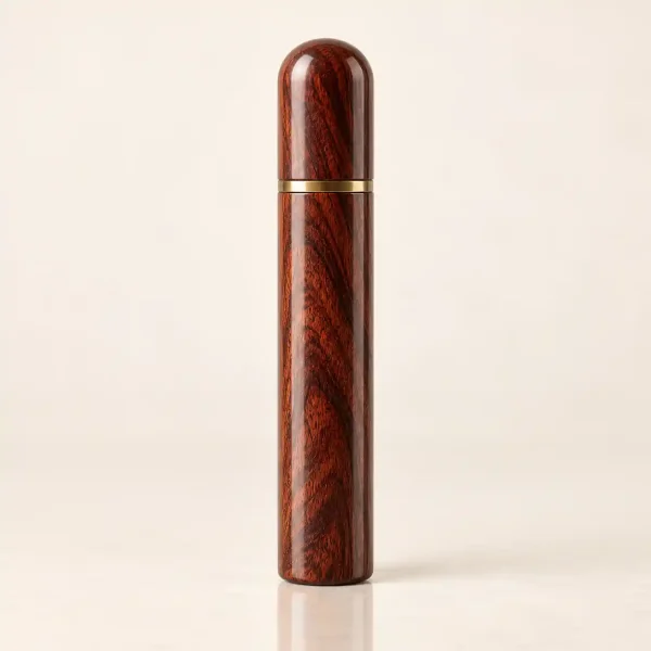 Rosewood needle case with a copper cap, standing upright